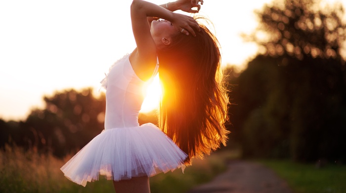 sunlight, arms up, ballerina, girl outdoors, hands on head, brunette