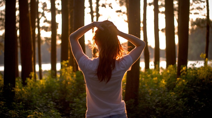 girl outdoors, sunlight, trees, hands on head
